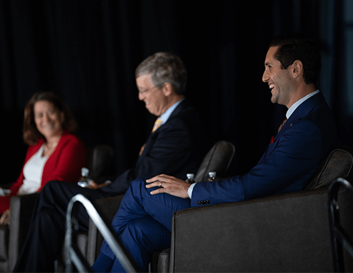 Panel-Speakers-Rural-Summit-Homepage-Callout Two male and one female sitting for a panel conversation